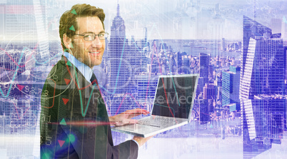 Composite image of smiling businessman using a laptop