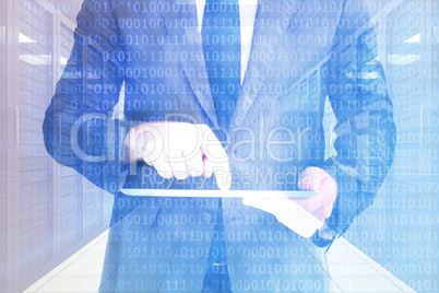 Composite image of businessman using his tablet pc