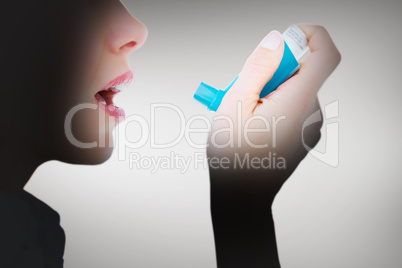 Composite image of close up of a woman using an asthma inhaler