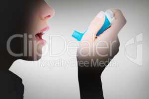 Composite image of close up of a woman using an asthma inhaler