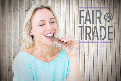 Composite image of pretty blonde enjoying and eating bar of choc