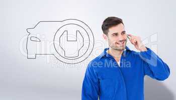 Composite image of happy young male mechanic using mobile phone