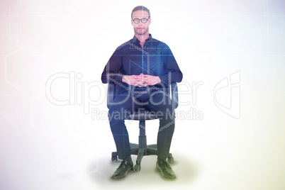 Composite image of stern businessman sitting on an office chair