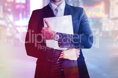 Composite image of mid section of businessman holding computer