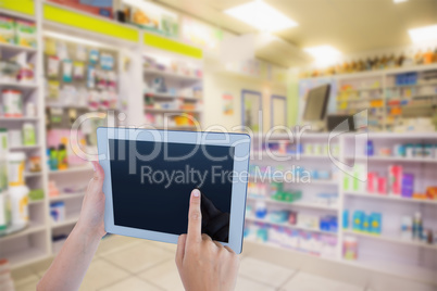 Composite image of woman using tablet pc