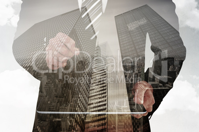 Composite image of businessman looking at tablet with magnifying