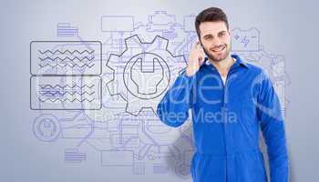 Composite image of smiling male mechanic using mobile phone