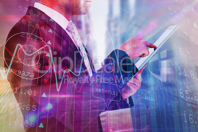 Composite image of businessman using his tablet pc