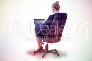 Composite image of businesswoman sitting on swivel chair with la