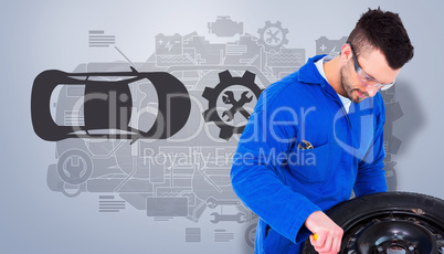 Composite image of mechanic working on tire