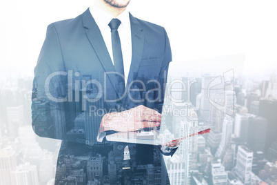 Composite image of mid section of a businessman using laptop