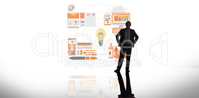 Composite image of businessman standing with hands on hips