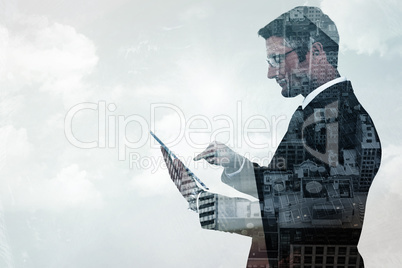 Composite image of mid section of a businessman touching tablet