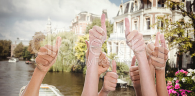 Composite image of hands up and thumbs raised