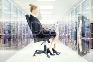 Composite image of businesswoman sitting on swivel chair with la