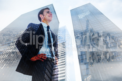 Composite image of cheerful businessman with hands on hips