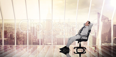 Composite image of businessman relaxing in swivel chair