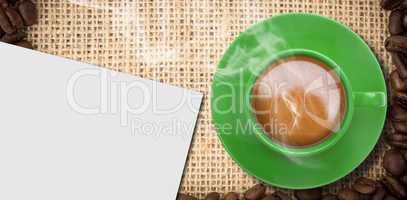 Composite image of green cup of coffee