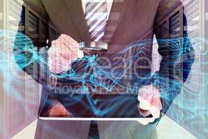 Composite image of businessman looking at tablet with magnifying