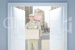 Composite image of happy delivery man carrying cardboard box