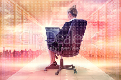 Composite image of businesswoman sitting on swivel chair with la