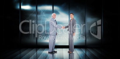 Composite image of business team shaking hands