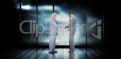 Composite image of business team shaking hands