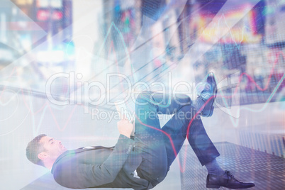 Composite image of businessman lying on the floor reading book