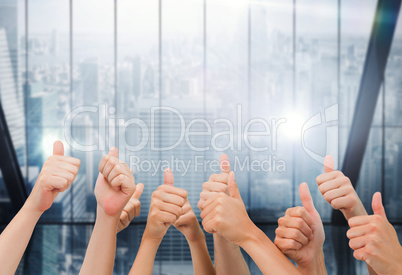 Composite image of group of hands giving thumbs up