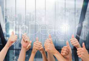 Composite image of group of hands giving thumbs up