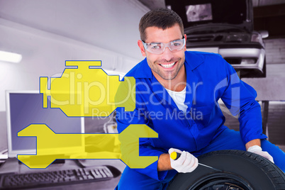 Composite image of portrait of happy mechanic working on tire