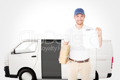 Composite image of happy delivery man holding cardboard box and