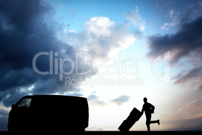 Composite image of happy delivery man with trolley of boxes runn