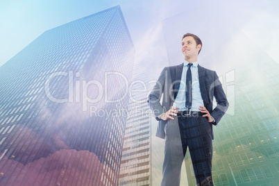 Composite image of happy businessman with hands on hips