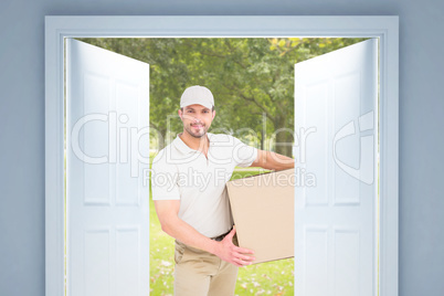 Composite image of delivery man with cardboard box