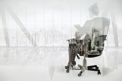 Composite image of businesswoman sitting on swivel chair with ta