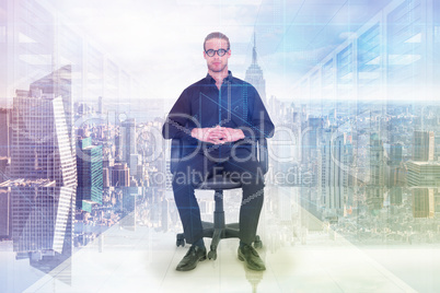 Composite image of stern businessman sitting on an office chair