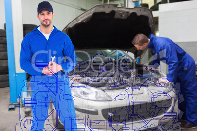 Composite image of smiling male mechanic holding spanner