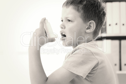 Boy using an asthma inhaler