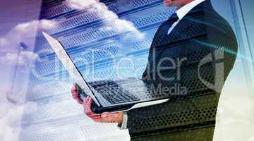 Composite image of businessman with watch using tablet pc