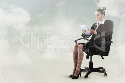 Composite image of businesswoman sitting on swivel chair with ta