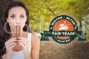 Composite image of pretty brunette eating bar of chocolate