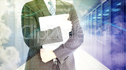 Composite image of businessman holding his laptop tightly