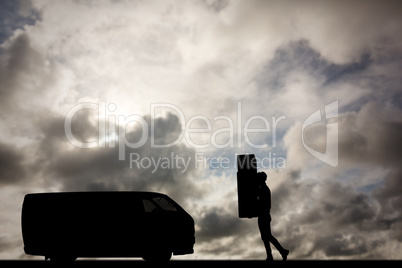 Composite image of delivery man carrying cardboard boxes