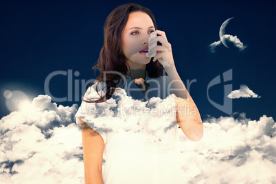 Composite image of asthmatic brunette using her inhaler