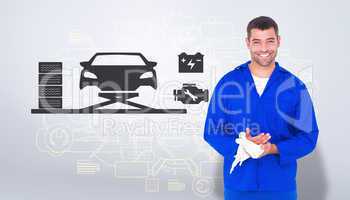 Composite image of smiling mechanic wiping hands with cloth