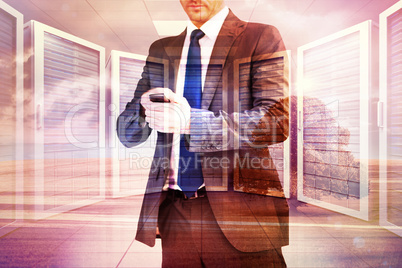 Composite image of focused businessman texting on his mobile pho