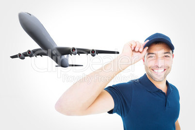 Composite image of smiling delivery man wearing cap on white bac
