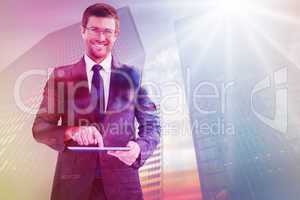 Composite image of businessman using his tablet pc