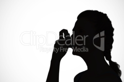 Composite image of woman using inhaler for asthma